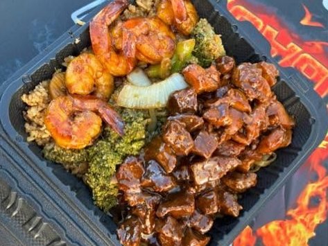 Steak bites and shrimp with broccoli, onion and fried rice