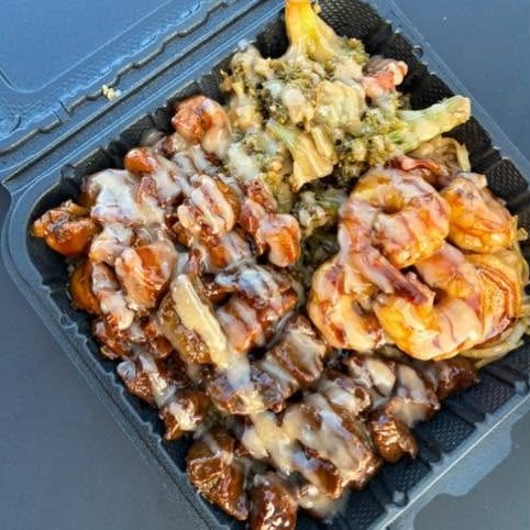 Steak bites and shrimp drizzled with yum yum sauce, broccoli and noodles
